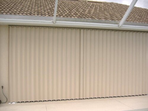 Accordion shutters closed, covering patio for storm protection.